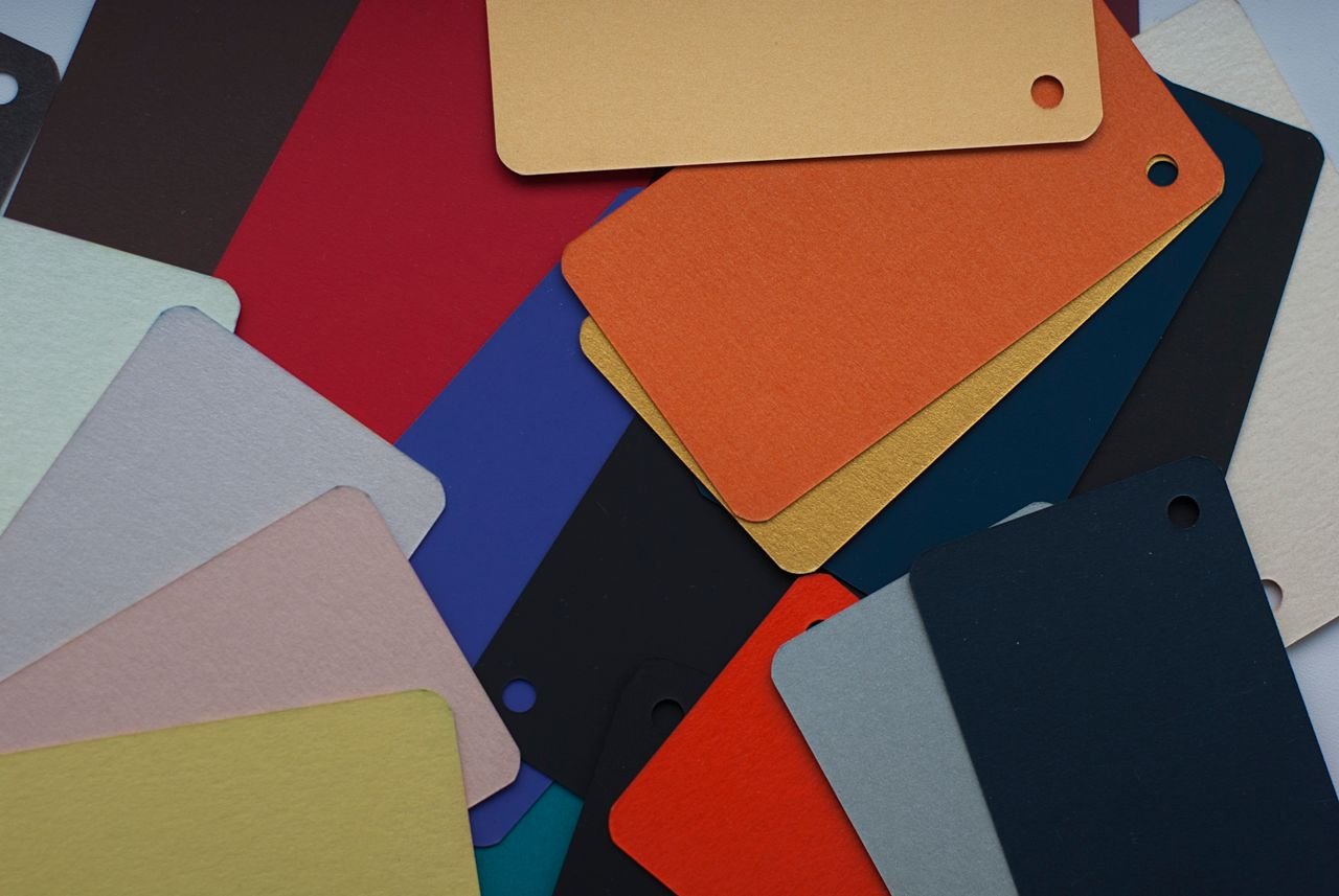 Top view of a vibrant selection of colorful cardboard swatches for design inspiration.