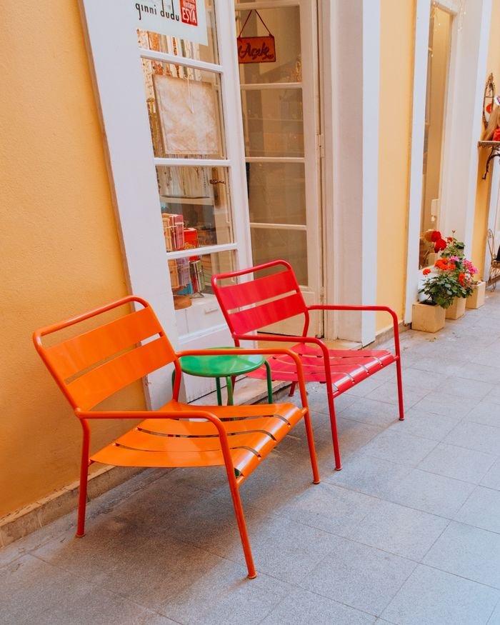 Vibrant red and orange chairs in Istanbul's French Passage offering a lively ambiance.